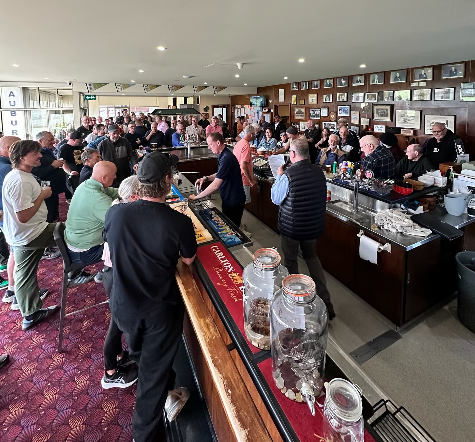A packed function in the Auburn clubrooms, with guests gathered around the bar